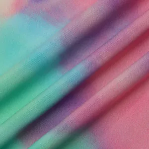 Close-up of vibrant tie-dye knit fabric showing fine texture and soft gradient colors