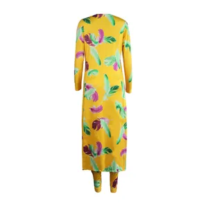 Back view of vibrant yellow two-piece set featuring colorful feather print patterns