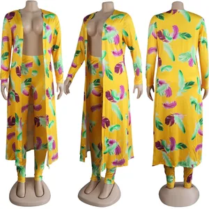 Detail of yellow two-piece set featuring vibrant feather print and long cardigan