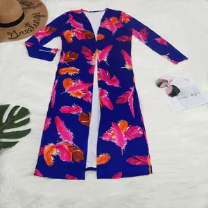 Detail view of long sleeve cardigan with vibrant pink and orange feather prints.