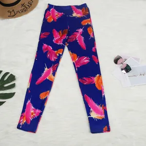 Detail view of blue leggings featuring vibrant pink and orange feather print patterns