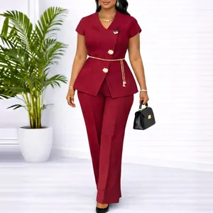 Elegant burgundy two-piece pant suit with short sleeves and gold floral buttons.