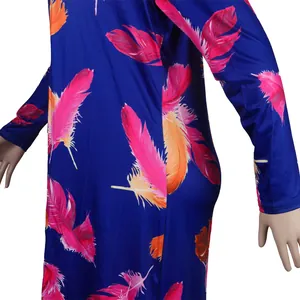Close-up detail of vibrant pink and orange feather print on blue long-sleeve dress fabric