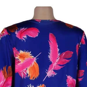 Detailed close-up of vibrant pink feather print on blue satin nightclub cardigan outfit.