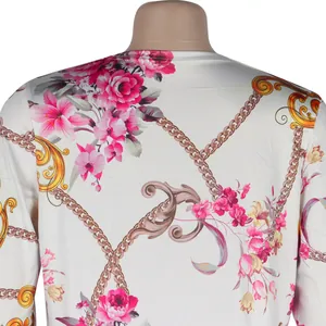 Close-up of floral and golden chain print pattern on white long-sleeve cardigan back.