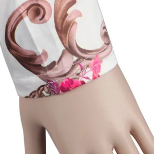 Close-up of baroque floral print sleeve cuff with detailed double stitching