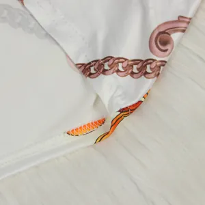 Close-up detail of white fabric with chain print and high-quality stitching