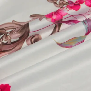 Detailed view showing the smooth texture of white fabric with pink floral and baroque prints.