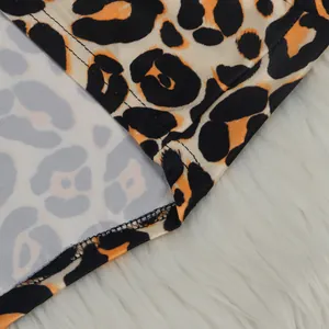 Detailed close-up showing the leopard print pattern and high-quality double stitching on the hem.