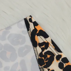 Macro detail showing the high-quality stitching and leopard print fabric texture of the garment
