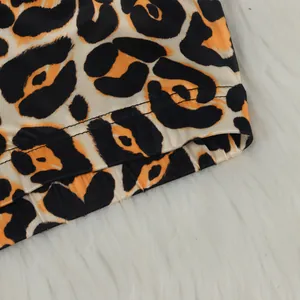 Detailing view of leopard print fabric with high-quality stitching on a cardigan