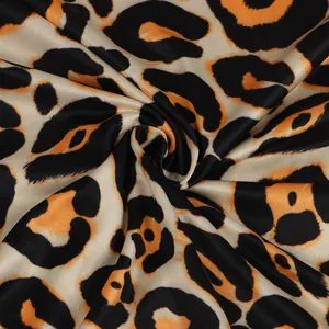 Close-up of vibrant leopard print fabric showing smooth texture and draping