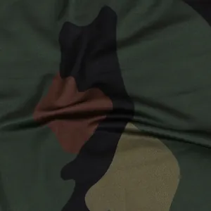 Detailed macro view of the camouflage print fabric texture used for women's two-piece outfit.
