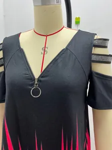 Close-up of V-neck zipper and cold-shoulder rhinestone straps on black T-shirt.