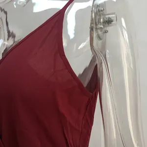 Detailed macro view showing the fine fabric and stitching of a red V-neck camisole garment
