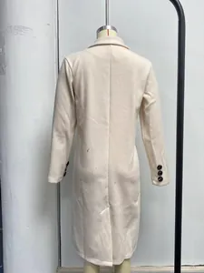 Detailed back view of a minimalist cream long-sleeved wool-look overcoat on a mannequin