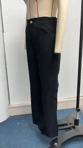 Side view detail of stylish high-waisted black corduroy flared pants for women