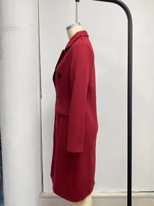 Detailed side view of a stylish red double-breasted wool coat on a mannequin stand
