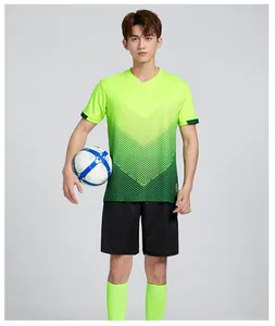 Professional Asian model in green gradient soccer training kit with ball and shorts