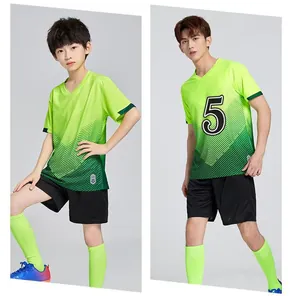 Professional studio shot showing full neon green soccer uniform set on young male models