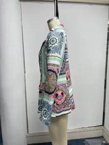 Detail side view of a vibrant baroque print blazer for women on a studio mannequin.