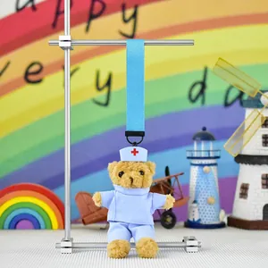 Cute nurse teddy bear plush toy hanging from a light blue strap for hospital gifts.