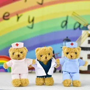 Detail of three medical professional teddy bears wearing pink, white, and blue scrubs and hats