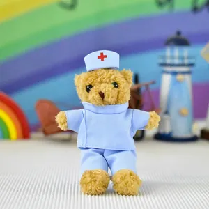 Adorable plush nurse teddy bear wearing blue scrubs and hat with a red cross