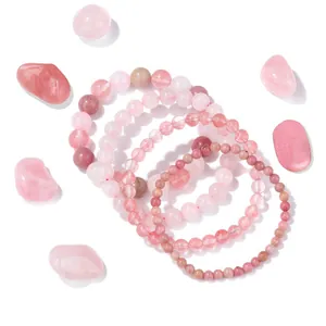Detailed view of rose quartz and rhodochrosite beaded bracelets with natural stones