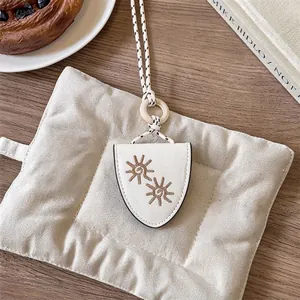 Vintage white leather glasses holder necklace with an elegant sun embroidery detail.