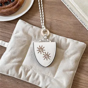 Close-up view of a retro leather glasses holder necklace with chic sun embroidery detail