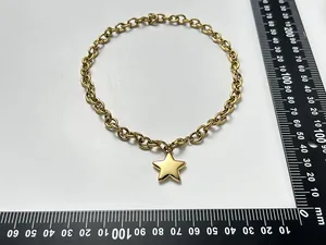 Detailed view of 18K gold plated stainless steel puffy star necklace with measurement scale