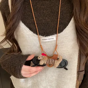 Close-up detail of a cute flocked dog glasses holder necklace with leather strap