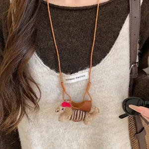 Close-up view of the cute flocked poodle charm on a leather eyeglass holder necklace
