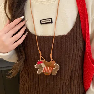Close-up of sweet flocked dog eyeglass holder necklace worn as a fashion accessory