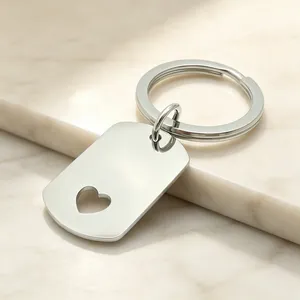 Détail d'un porte-clés en acier inoxydable avec découpe en forme de cœur.