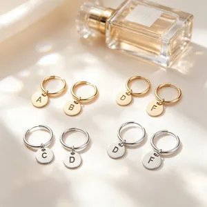 Elegant stainless steel initial letter disc hoop earrings in gold and silver finish
