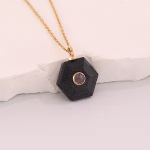 Detailed view of a hexagonal black sandstone pendant featuring a sparkling inset stone