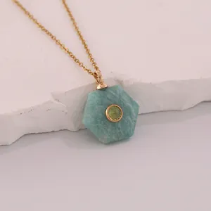 Close-up of hexagonal natural stone pendant on gold stainless steel chain