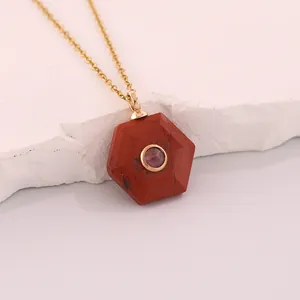 Close-up of a hexagonal red natural stone pendant necklace with central purple crystal