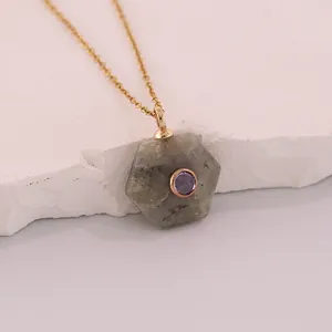 Detailed macro shot of hexagonal natural stone pendant with purple zircon inlay