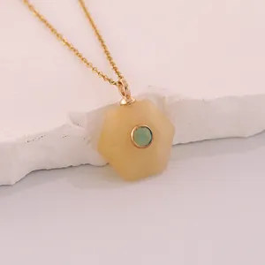 Close-up of a hexagonal yellow natural stone pendant necklace with a blue center gem