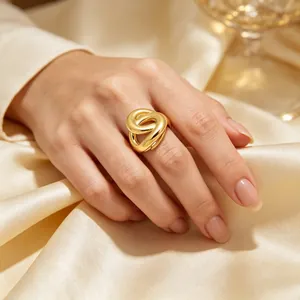 Gros plan d'une bague géométrique torsadée irrégulière en acier plaqué or 18 carats
