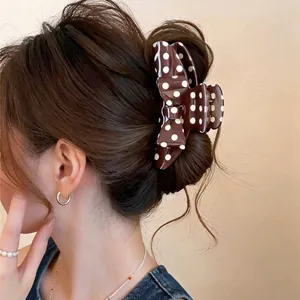 Retro dark brown acrylic hair claw clip with white polka dot bow design for women