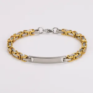 Close-up of a two-tone stainless steel Byzantine chain bracelet with curved ID plate.