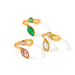 Close-up of 18k gold plated stainless steel rings with green, pink and clear zircons.