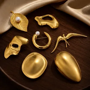 Creative gold-plated stainless steel brooches in various abstract and nature-inspired shapes.
