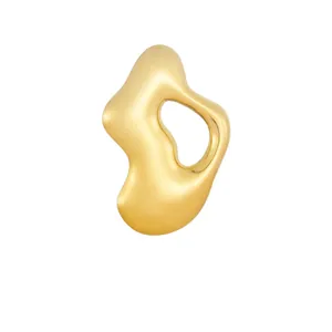 Detailed view of the smooth golden finish on the organic-shaped stainless steel brooch