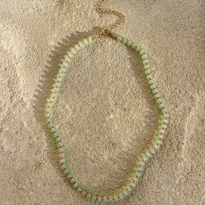 Detailed view of green abacus stone beads with pink hand-knotted thread necklace.
