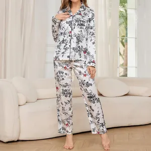 Elegant women's faux silk pajama set with black floral print and red bow accents